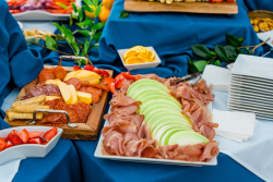 meats cheese and fruits at event
